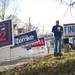 Hunter Vanvalkenburgh walks on the sidewalk outside the Ann Arbor Community Center on Tuesday. Vanvalkenburgh is informing voters of the non-partisan ballot as well as who the democratic candidate is. Daniel Brenner I AnnArbor.com